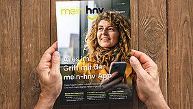 Ein Mann hält die Ausgabe Oktober 2026 des mein-hnv Magazins in den Händen.